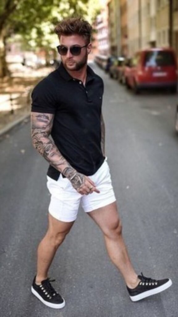 a man with tattoos on his arm and a skateboard
