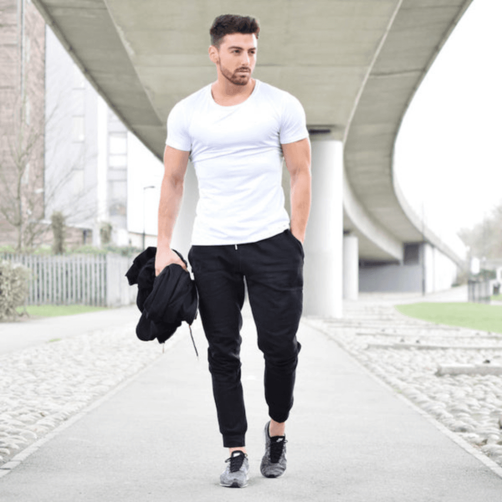 7 Stylish Ways to Rock a Plain White TShirt for Men a man wearing white t-shirt with joggers and athletic shoes for a comfortable yet stylish outfit